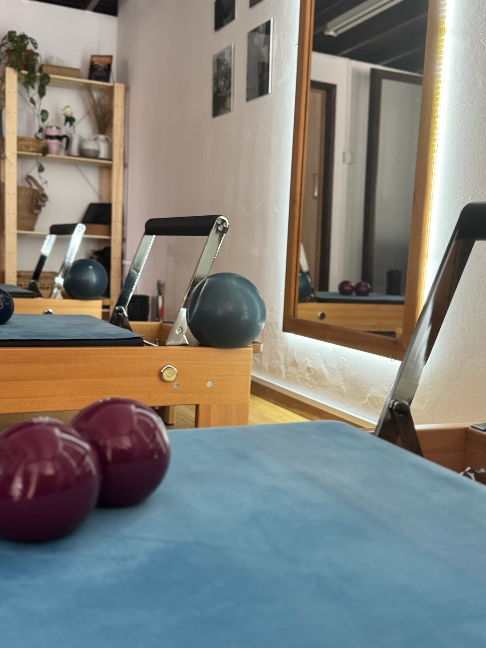 Reformer studio with props, mirror, and soft light